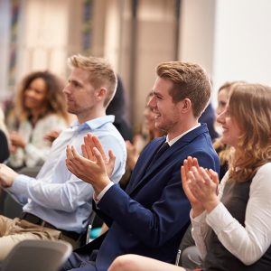 Audience Applauding Speaker After Conference Presentation